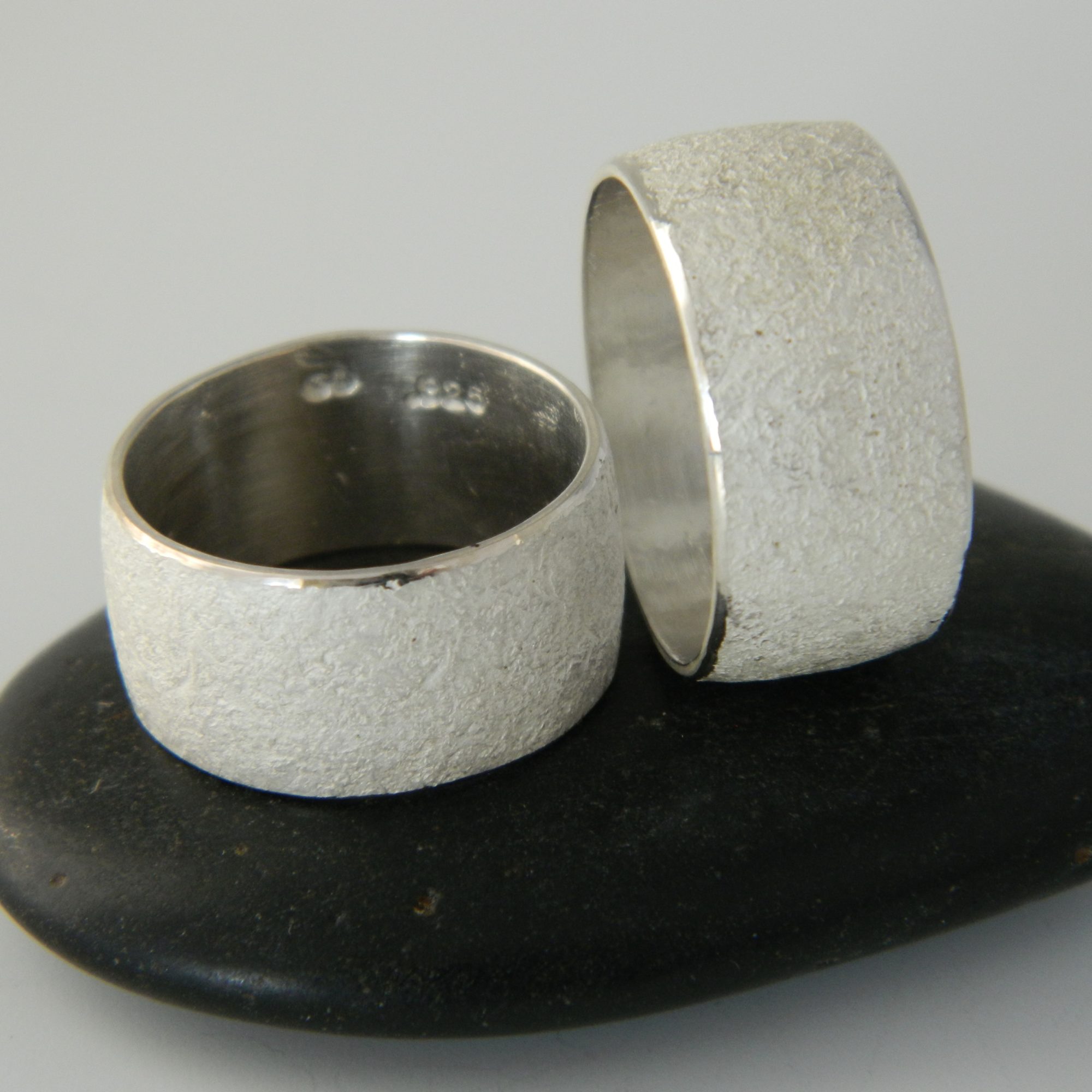 low dome wide rock textured silver bands