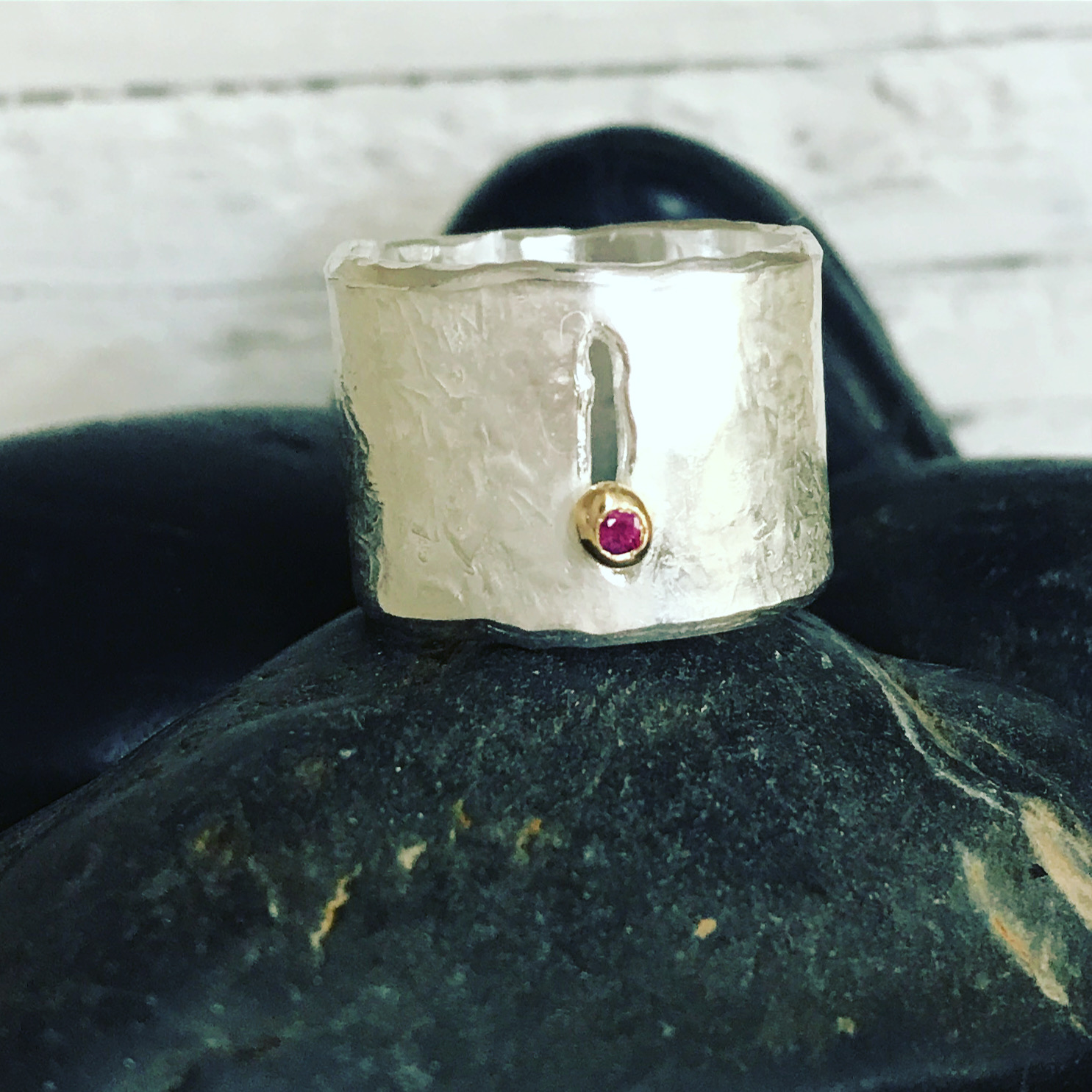silver and gold yoni ring with ruby